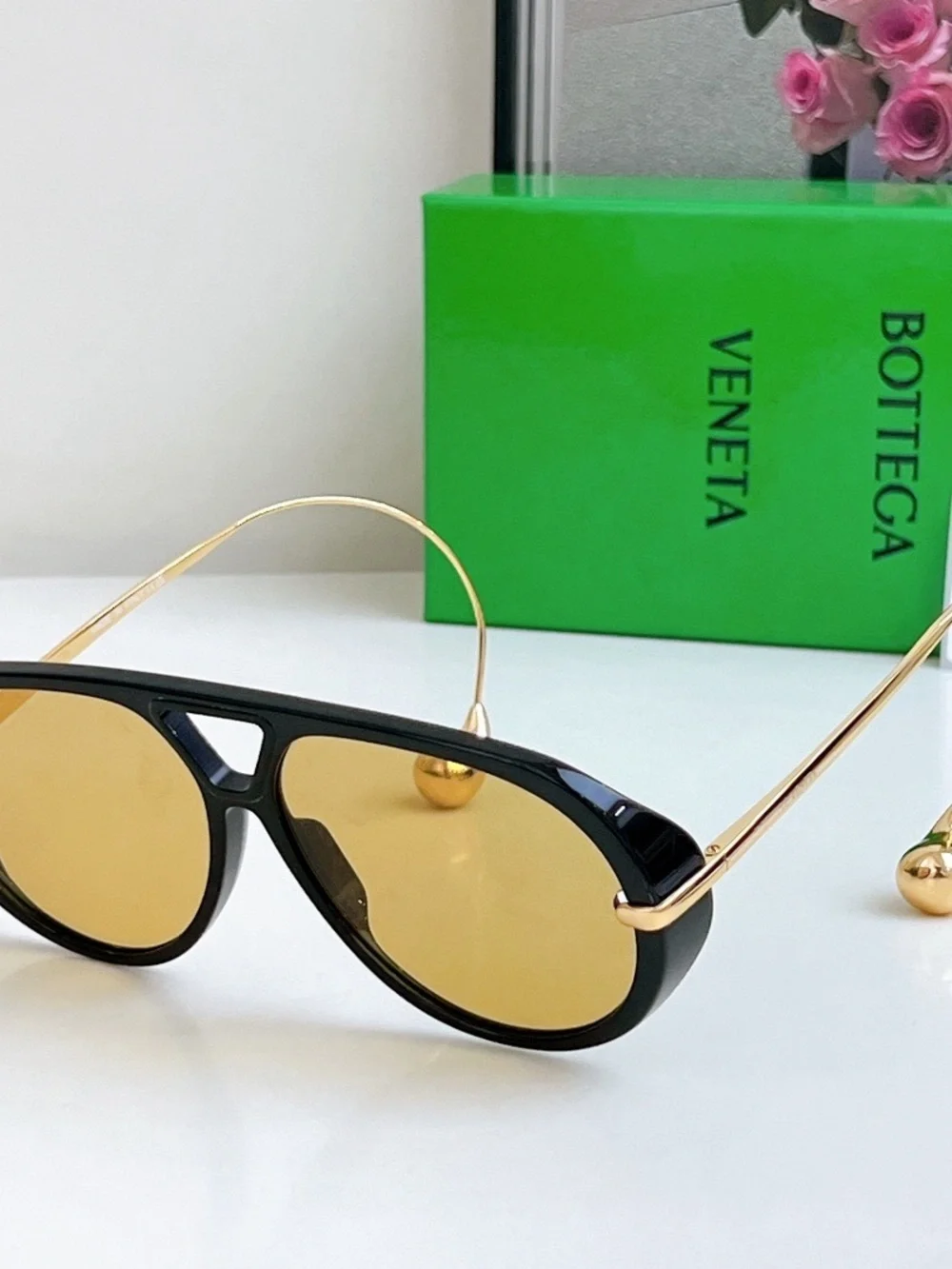Bottega Veneta Black Frame Sunglasses with Amber Lenses and Gold Details